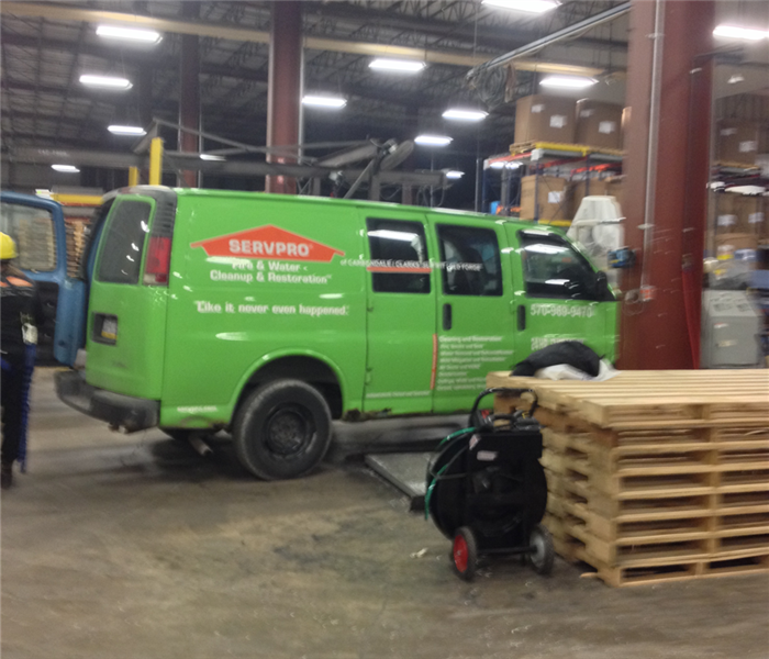 A SERVPRO truck parked inside a local manufacturing facility