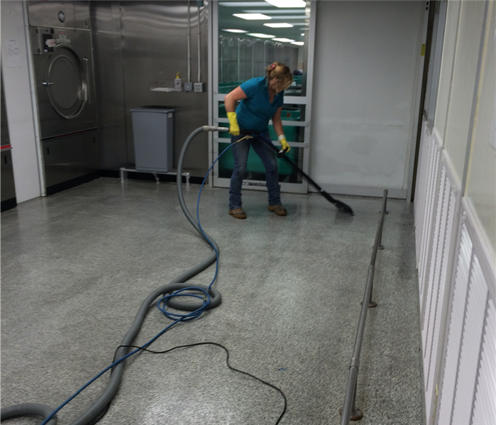 A SERVPRO employee using the extractor to clean a floor.