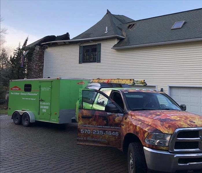 A SERVPRO truck pulling our construction trailer to start a re-construction project 